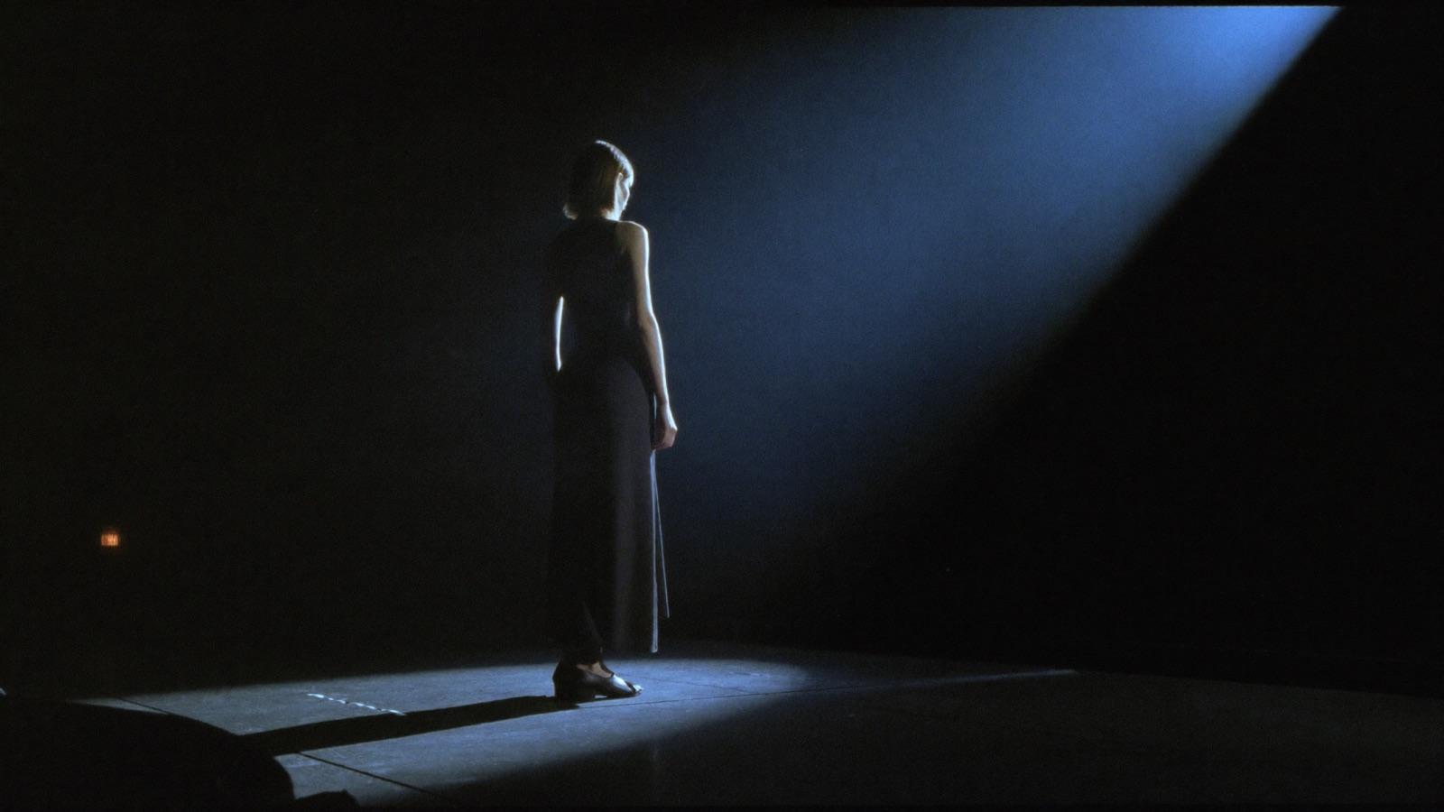 An actress in a spotlight on an audition stage
